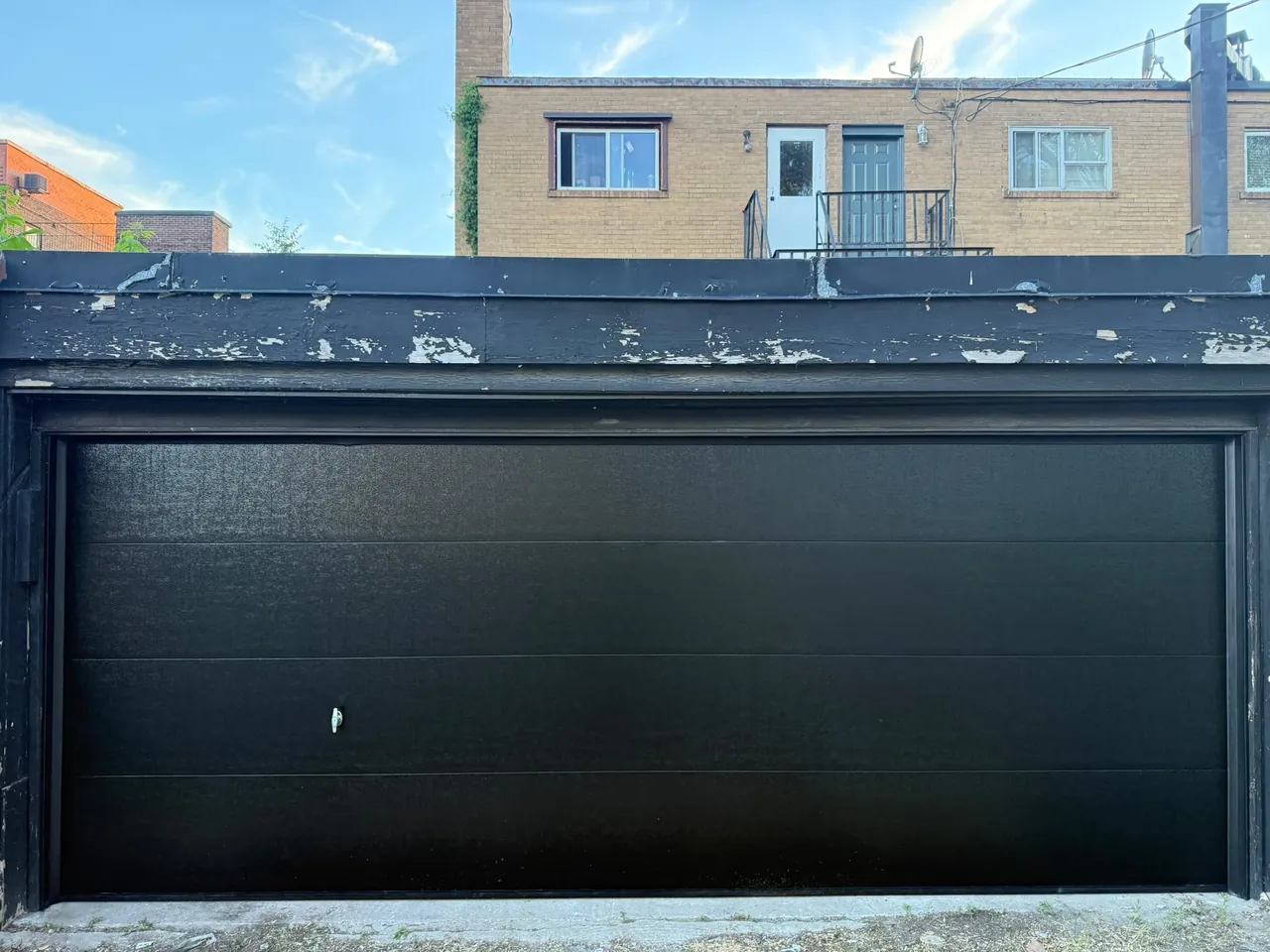 Black flush-panel garage door replacement