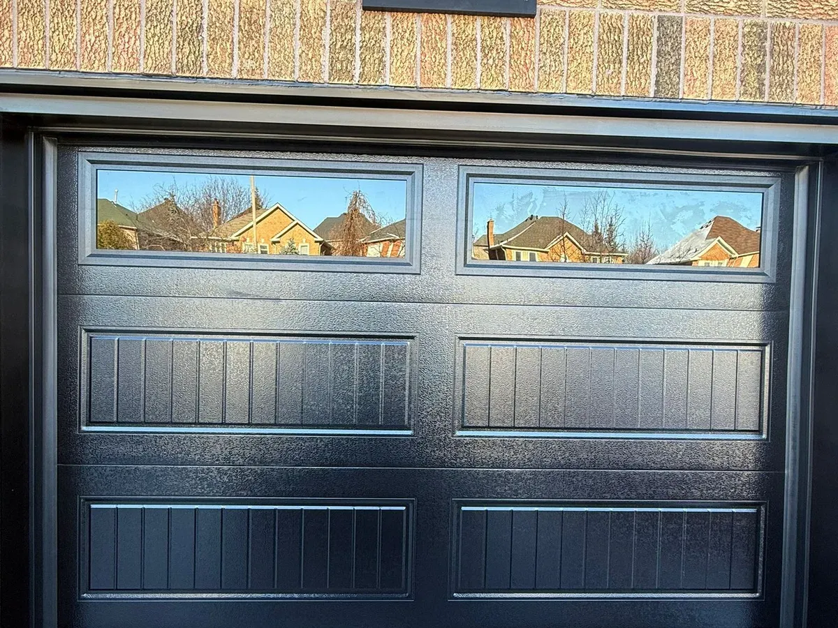 Premium black flush-panel door on stone home