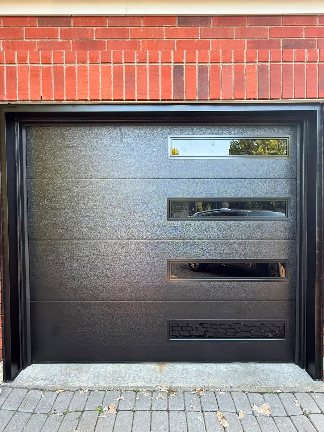 Black modern flush-panel single garage door with side windows
