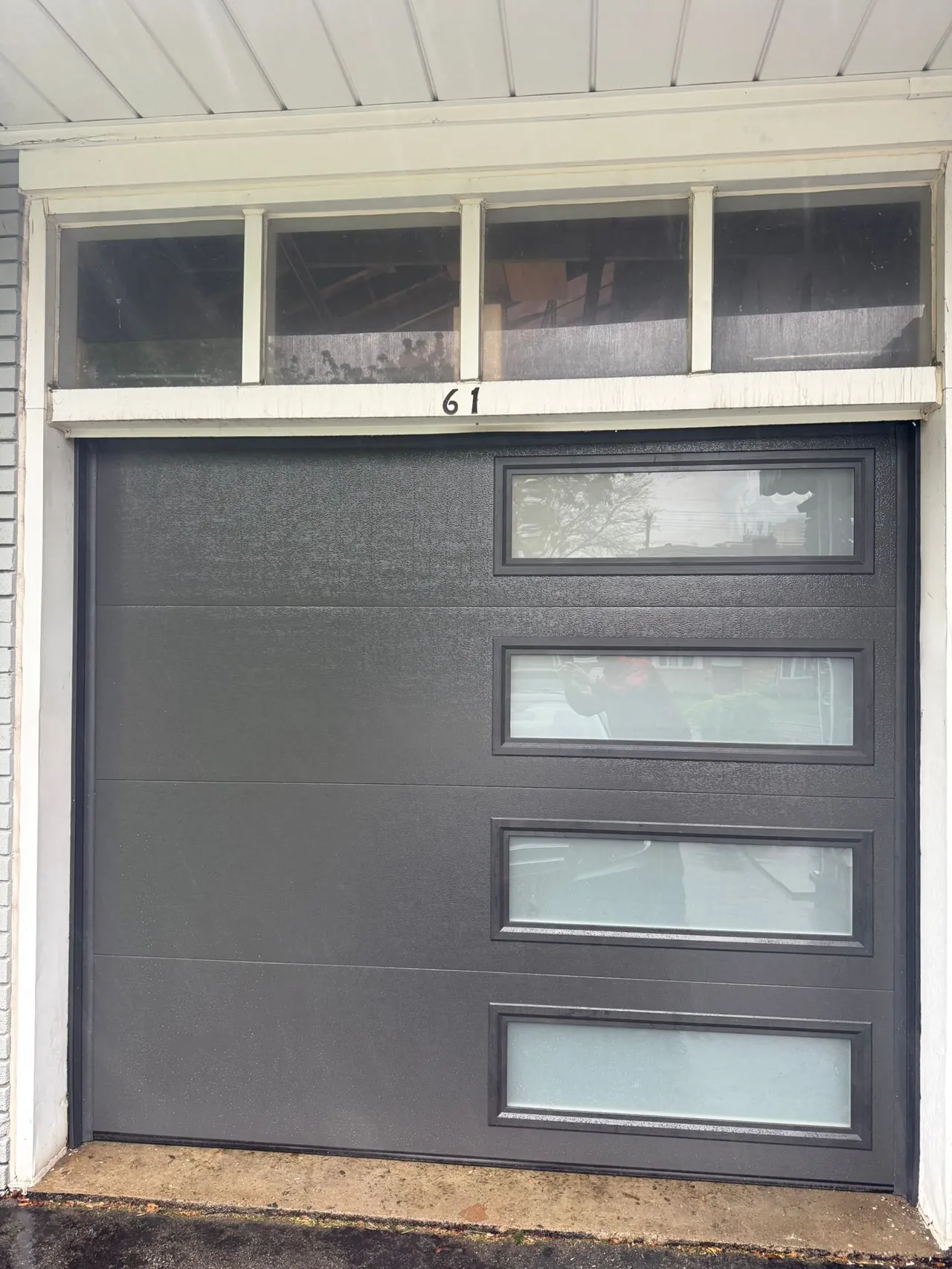 Charcoal modern flush-panel garage door with side windows