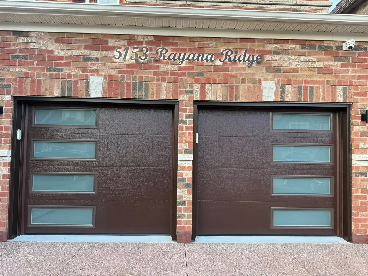 Espresso modern flush-panel double garage door with windows