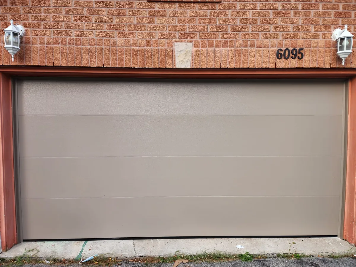 Beige flush-panel double garage door installation