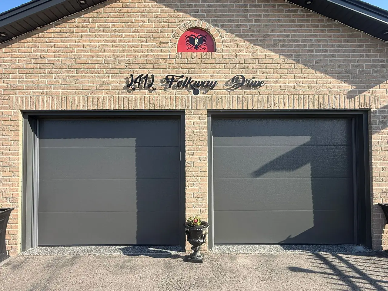 Graphite modern flush-panel double garage door close-up
