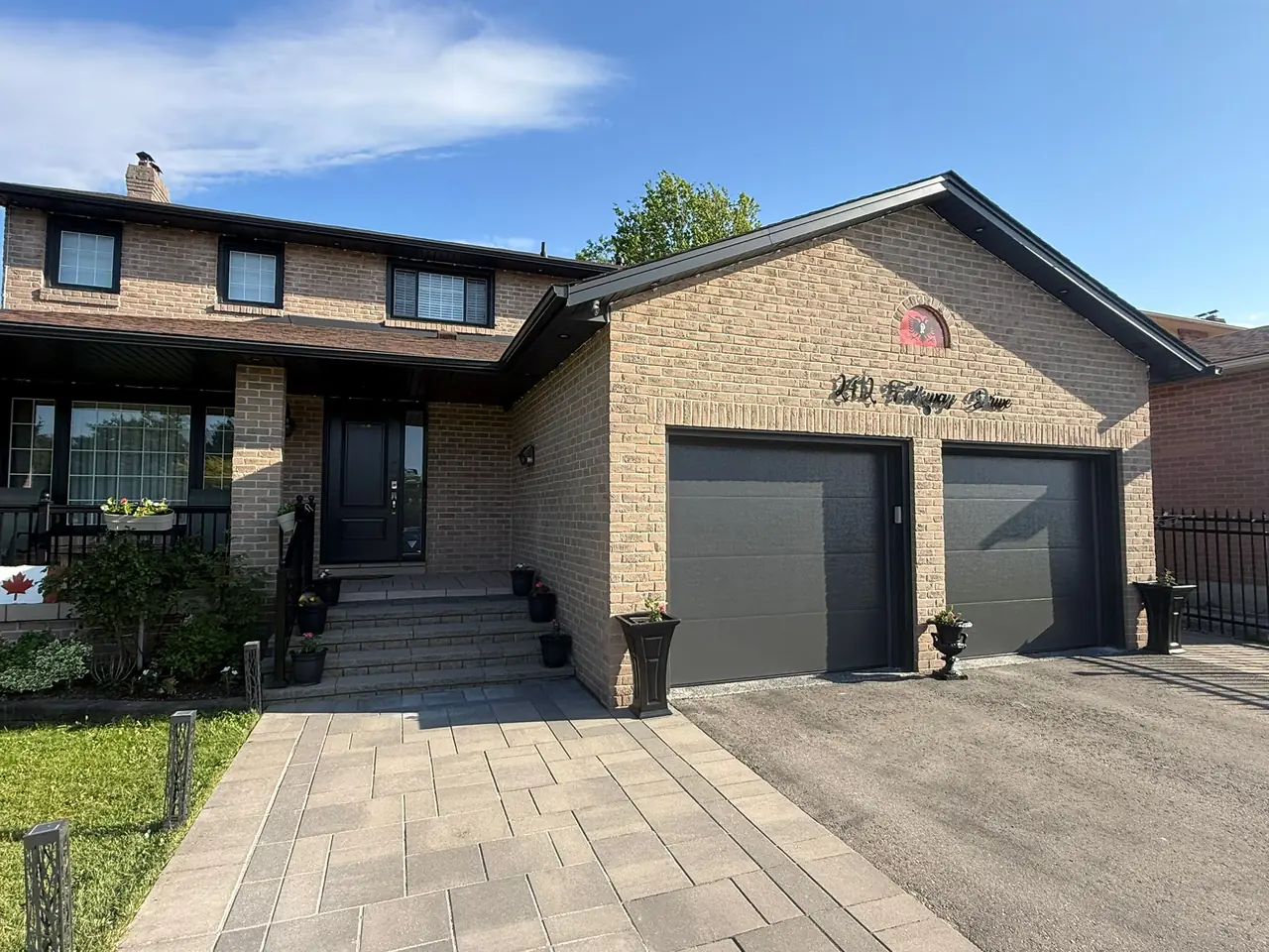 Graphite modern flush-panel double garage door installation