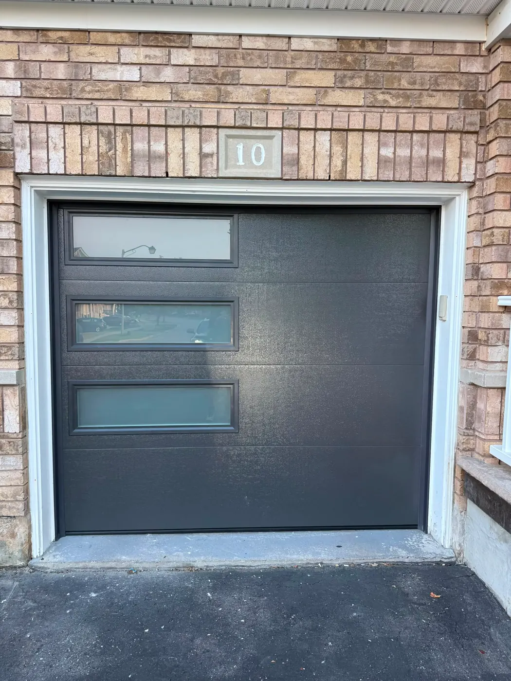 Graphite modern flush-panel single garage door with side windows