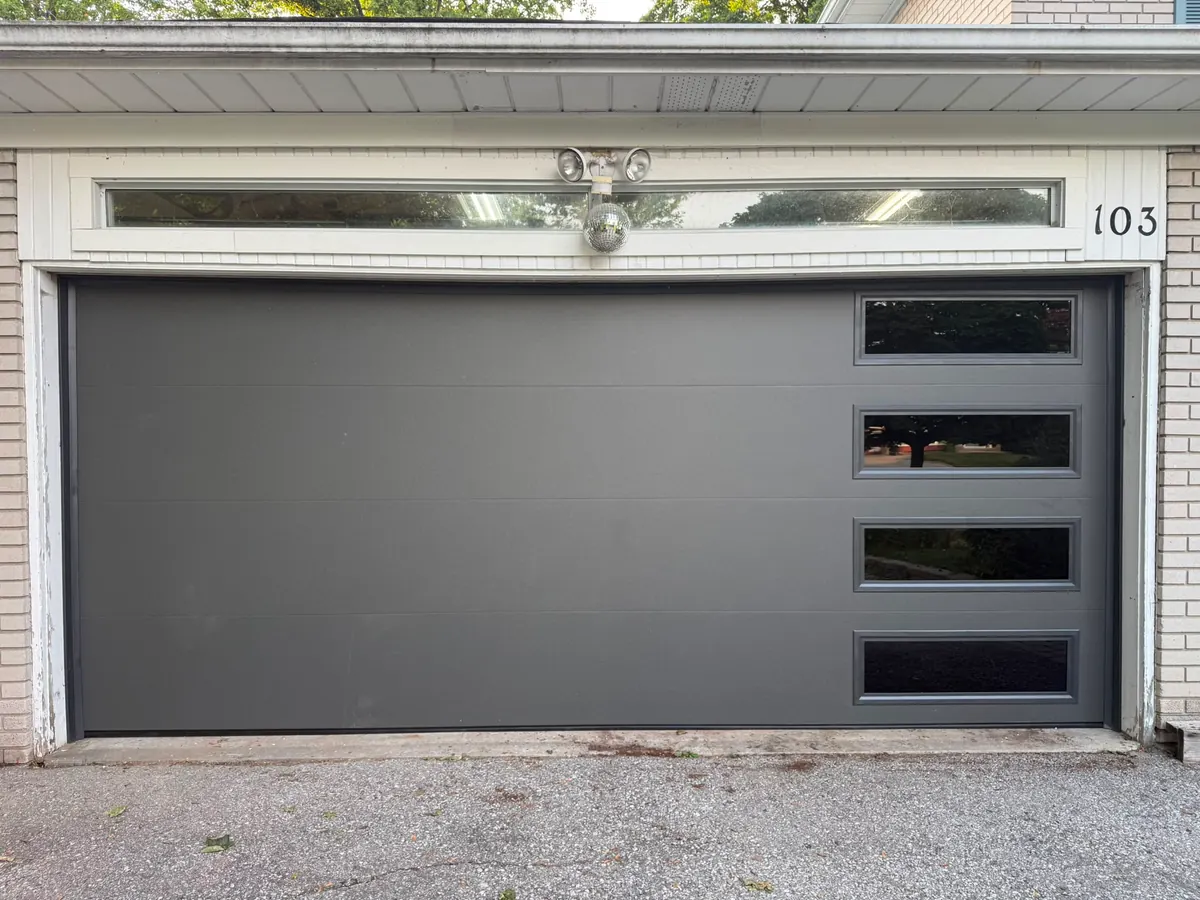 Grey modern flush-panel double garage door with side windows
