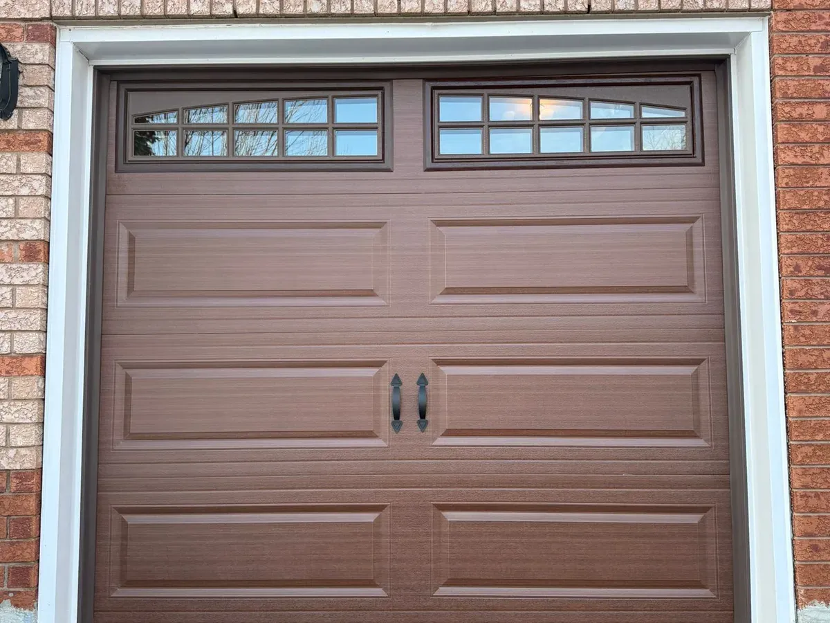 Insulated white garage door with hardware