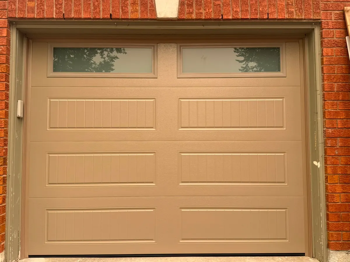 Tan carriage-panel single garage door with top windows